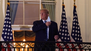In October 2020, the President and First Lady tested positive for Covid-19. Donald Trump was treated at a military hospital and said he was "immune" when discharged. Here he is pictured taking off a face covering after arriving back at the White House