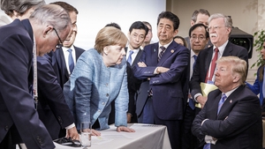 German Chancellor Angela Merkel deliberates with Donald Trump on the sidelines of the G7 summit in Canada. Other leaders seen in the picture are French president Emmanuel Macron and then British prime minister Theresa May