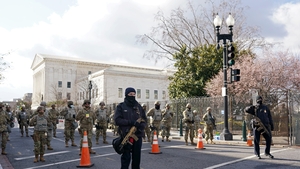 Members of the National Guard and law enforcement gather near the US Capitol