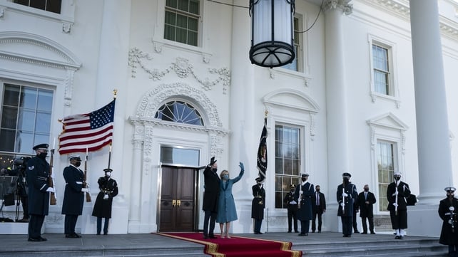 Joe and Jill Biden wave to reporters and supporters as they arrive at the White House