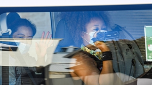 Women's world number three tennis player Naomi Osaka uses a video camera as she returns to her hotel after a practice session in Australia