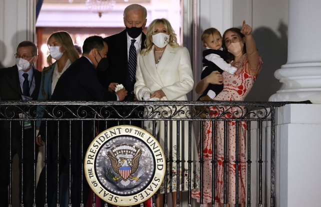 The Biden family watch a fireworks show on the National Mall from the Truman Balcony at the White House
