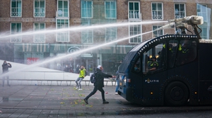 Police in Eindhoven intervene with water cannon during a January protest against the curfew