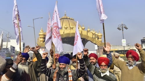 Farmers raising slogans during a protest against the central government's new farm laws, at Golden Gate