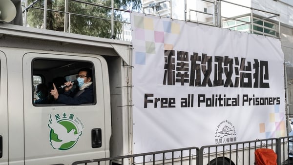 Activist chants protest slogans inside a van outside the Lai Chi Kok Reception Centre