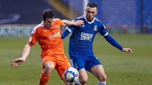 Troy Parrott battles for possession with Blackpool's Matty Virtue