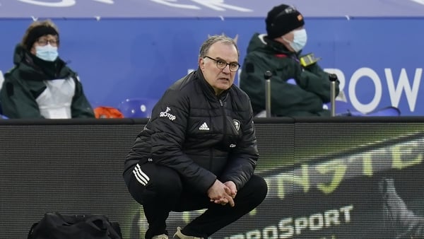Leeds United manager Marcelo Bielsa crouches on the touchline