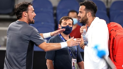 Fabio Fognini argues with Salvatore Caruso as the world number 78 prepares to leave the court