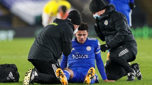 Leicester City's James Justin receives treatment