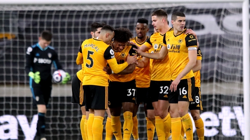 Wolves players celebrate after Leeds United goalkeeper Illan Meslier scores an own goal