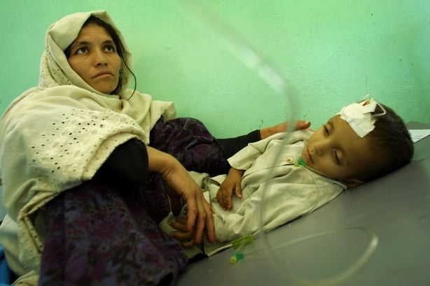Woman looking over her son who has dysentery