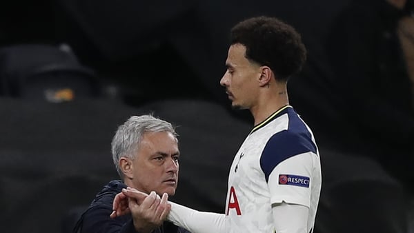 Dele Alli (R) shakes hands with Jose Mourinho after coming off
