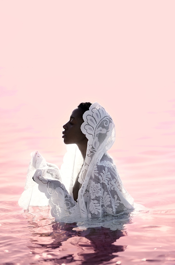 A woman stood in pink water