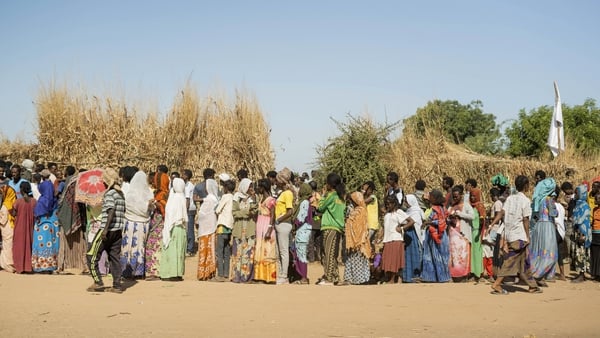 Ethiopian refugees from Tigray region wait in line to receive aid at the Um Rakuba refugee camp