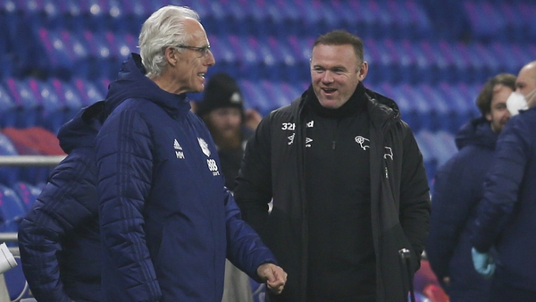 Mick McCarthy and Wayne Rooney share some touchline banter during Tuesday night's game