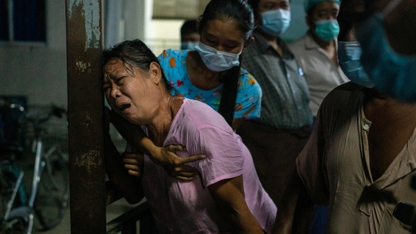 The mother of a protester mourns at a hospital after her son was killed during clashes in Yangon