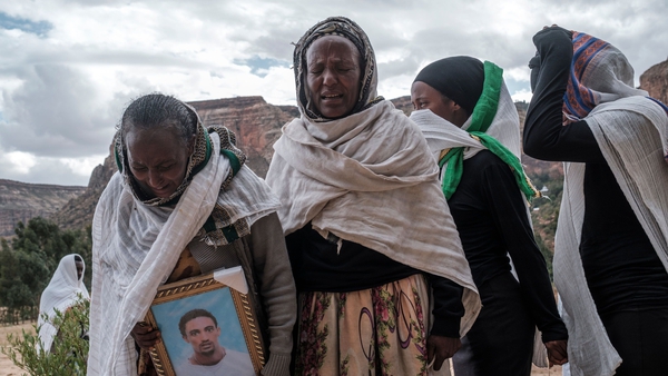 People gather to mourn the victims of a massacre allegedly perpetrated by Eritrean soldiers in the village of Dengolat