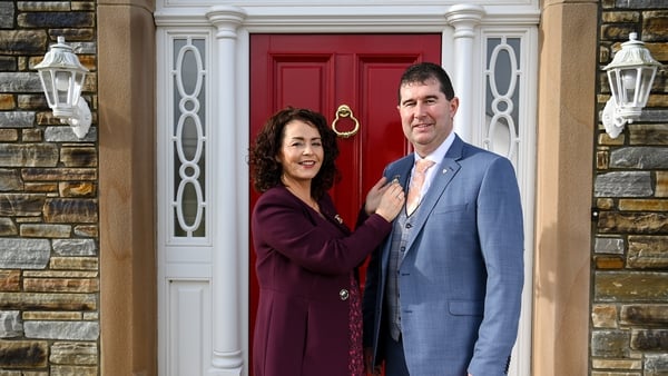 Mícheál Naughton is presented with his Presidential medal by his wife, Annette