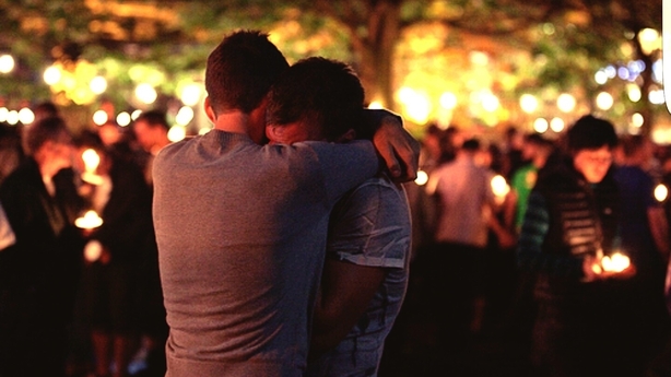 two men hugging and grieving