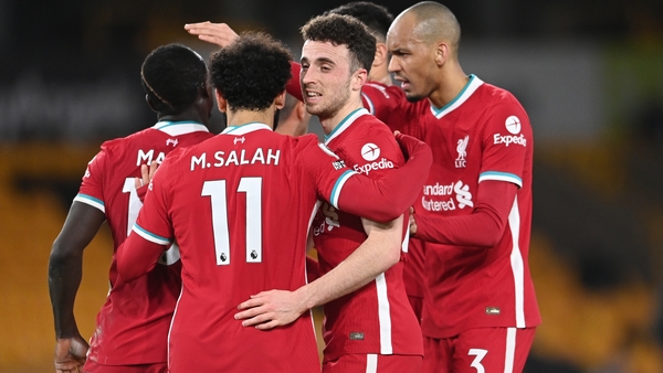 Diogo Jota (C) celebrates with his Liverpool team-mates after scoring at Molineux