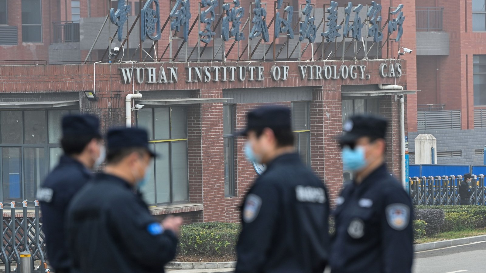 Image - Security stand guard outside the Wuhan Institute of Virology as members of the World Health Organisation visit the institute