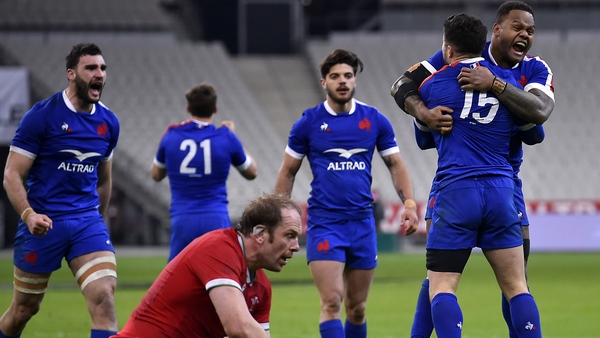 French players celebrate their late match-winning try as Wales captain Alun Wyn Jones