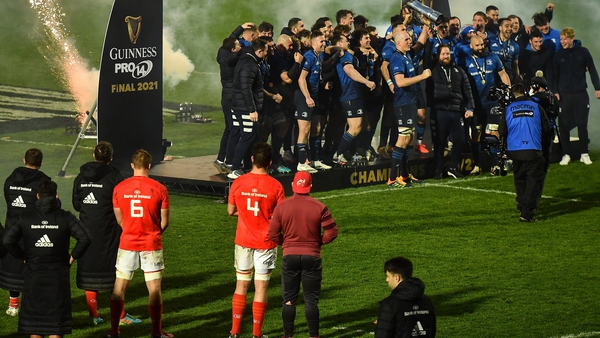 Munster players look on as Leinster celebrate another title