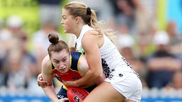 Collingwood's Sarah Rowe tackles Sarah Allan at Norwood Oval