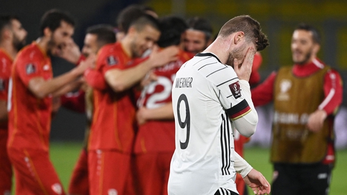 North Macedonia players celebrate as a dejected Timo Werner heads for the tunnel