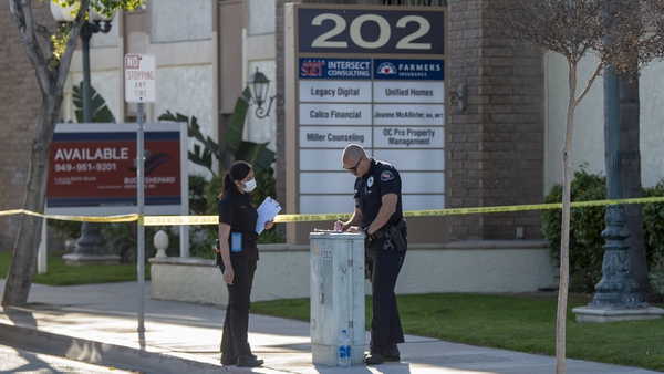 Police near the scene where four people were killed in Orange, California