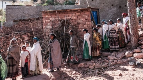 People gather to mourn the victims of a massacre allegedly perpetrated by Eritrean Soldiers in the village of Dengolat