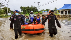 Rescuers evacuating people on a rubber boat today during a flood in Waingapu, East Nusa Tenggara, Indonesia