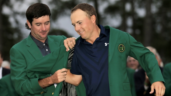 Bubba Watson helps Jordan Spieth put on the famous green jacket after he won the 2015 Masters