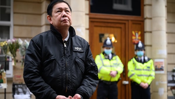 Kyaw Zwar Minn listens to a statement being read on his behalf as he stands outside the Myanmar Embassy in London
