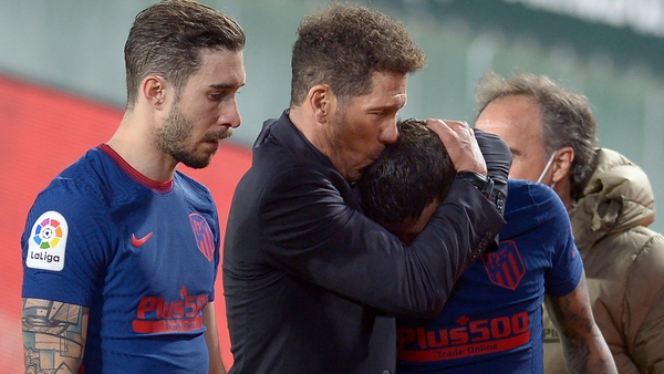 Atletico Madrid boss Diego Simeone comforts his compatriot Angel Correa after their draw against Real Betis