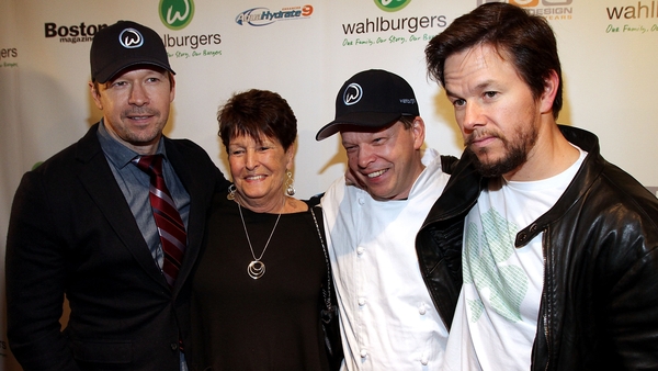 (L-R) Donnie Wahlberg, his mother Alma and brothers Paul and Mark at the opening of the family's Wahlburgers restaurant at the Hingham Shipyard in Boston, Massachusetts in October 2011