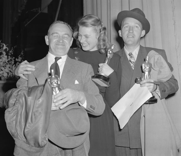 The Winners. Hollywood, Calif.: Barry Fitzgerald (left), Ingrid Bergman and Bing Crosby (right) hold "Oscars" awarded them for outstanding performances in 1944. Fitzgerald was named best supporting actor for his role in Going My Way, in which picture Crosby's leading role won him best male actor award. Miss Bergman, best female actress, won top honors for her acting in Gaslight. Awards were made at Annual Motion Picture Academy presentations.