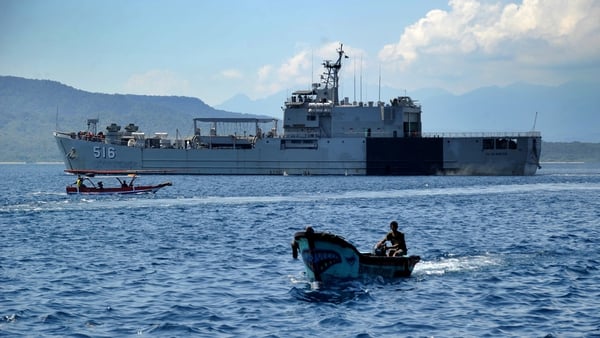 An Indonesia Navy ship sets off from the Tanjungwangi port near the naval base in Banyuwangi, East Java province
