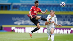 Bruno Fernandes vies for possession with Leeds United midfielder Kalvin Phillips