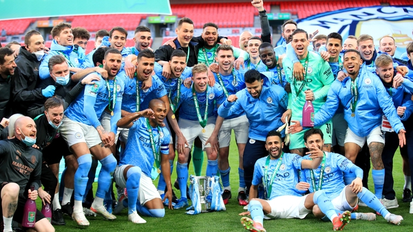 City players and staff celebrate with the trophy