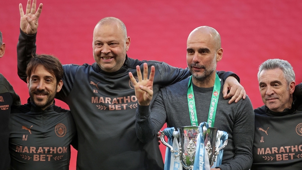 Pep Guardiola (second right) and his coaches pose with the Carabao Cup trophy