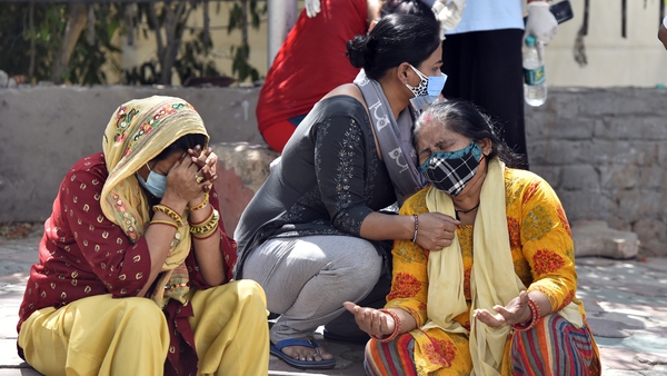 Grieving relatives of Covid victims wait outside a mortuary in New Delhi, India