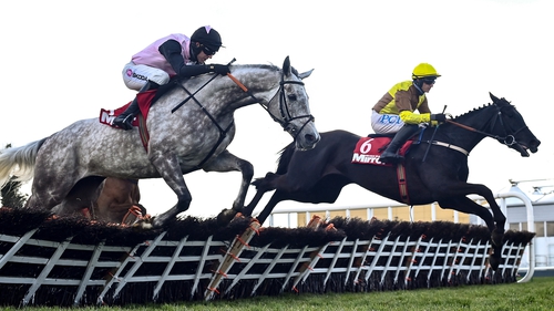 Galopin Des Champs (R) with Paul Townend up, jumps the sixth on their way to winning the Irish Mirror Novice Hurdle