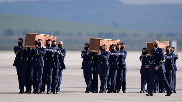 The coffins were taken off the plane by soldiers at the airport
