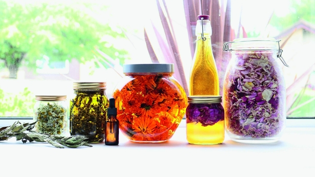 Jars and bottles of botanical oils with herbal infusions (Tanya Anderson/PA)
