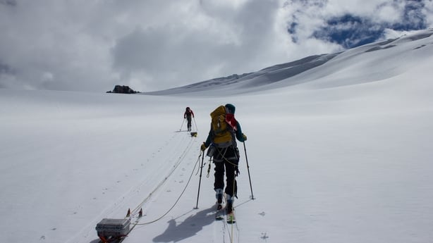 Scientists carrying out measurements on Conrad Glacier, Canada