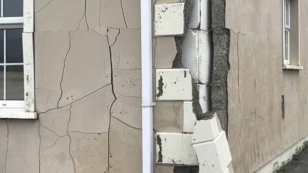 The external wall of a home crumbling due to the presence of mica