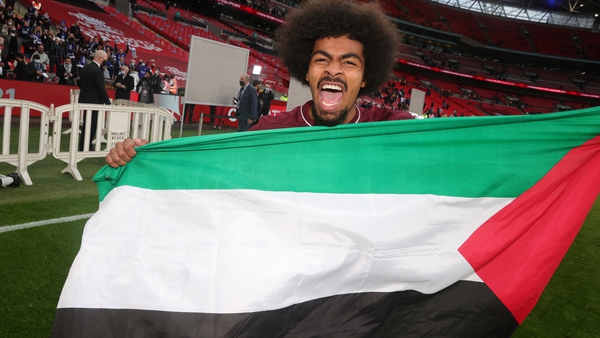 Hamza Choudhury celebrates with a Palestinian flag