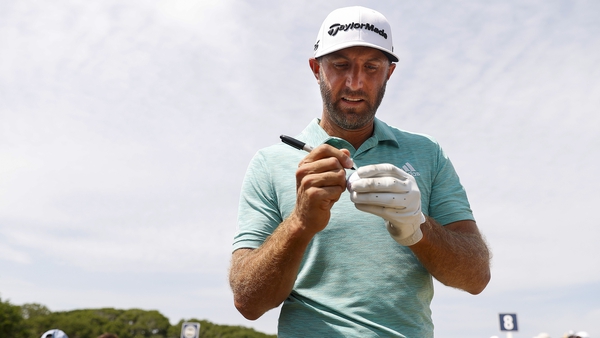 Dustin Johnson signs autographs during a practice round prior to the 2021 PGA Championship at Kiawah Island
