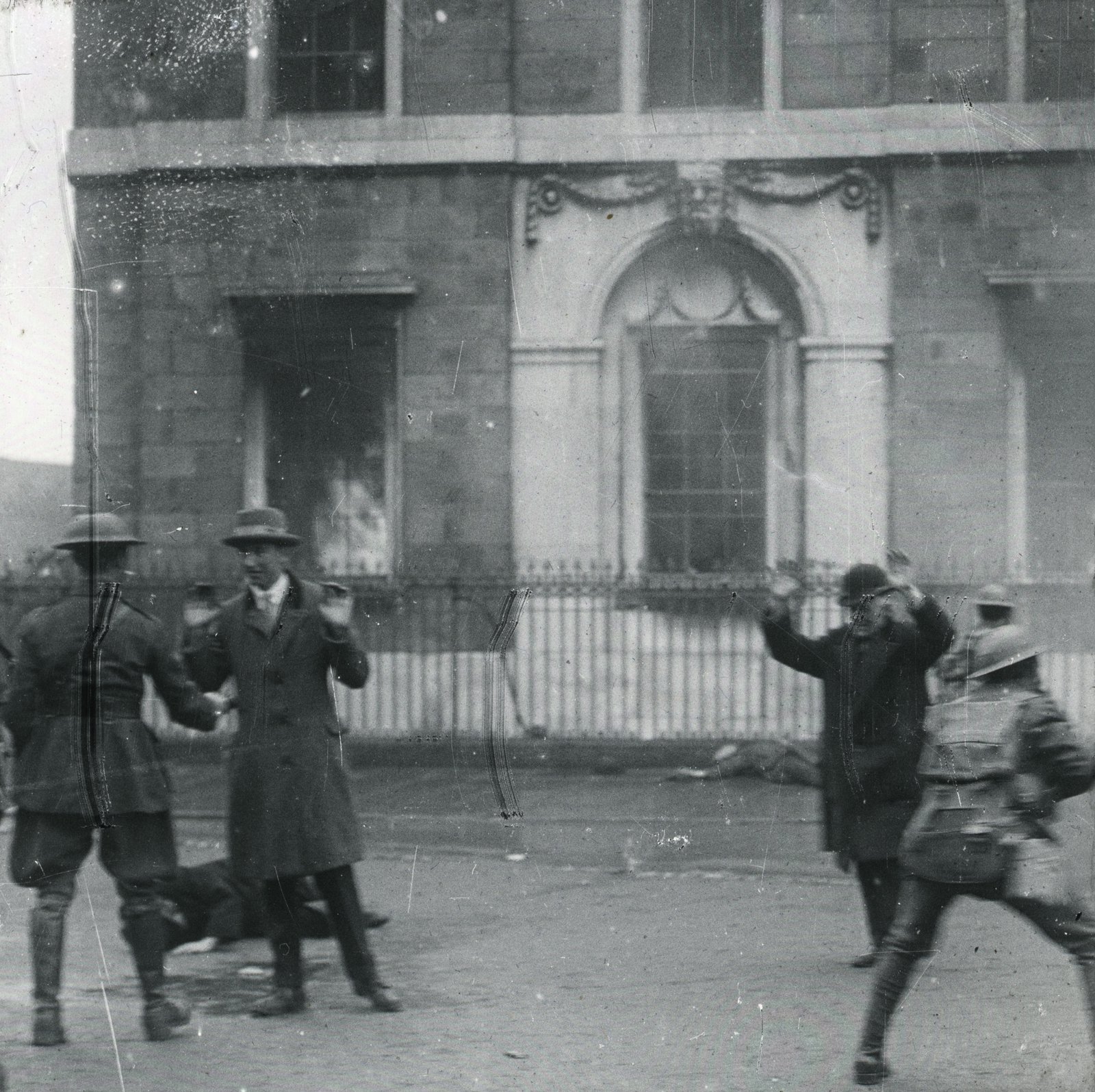 Image - Men escaping from the building are challenged by troops; are they civilians or Volunteers? Credit: South Dublin County Libraries.